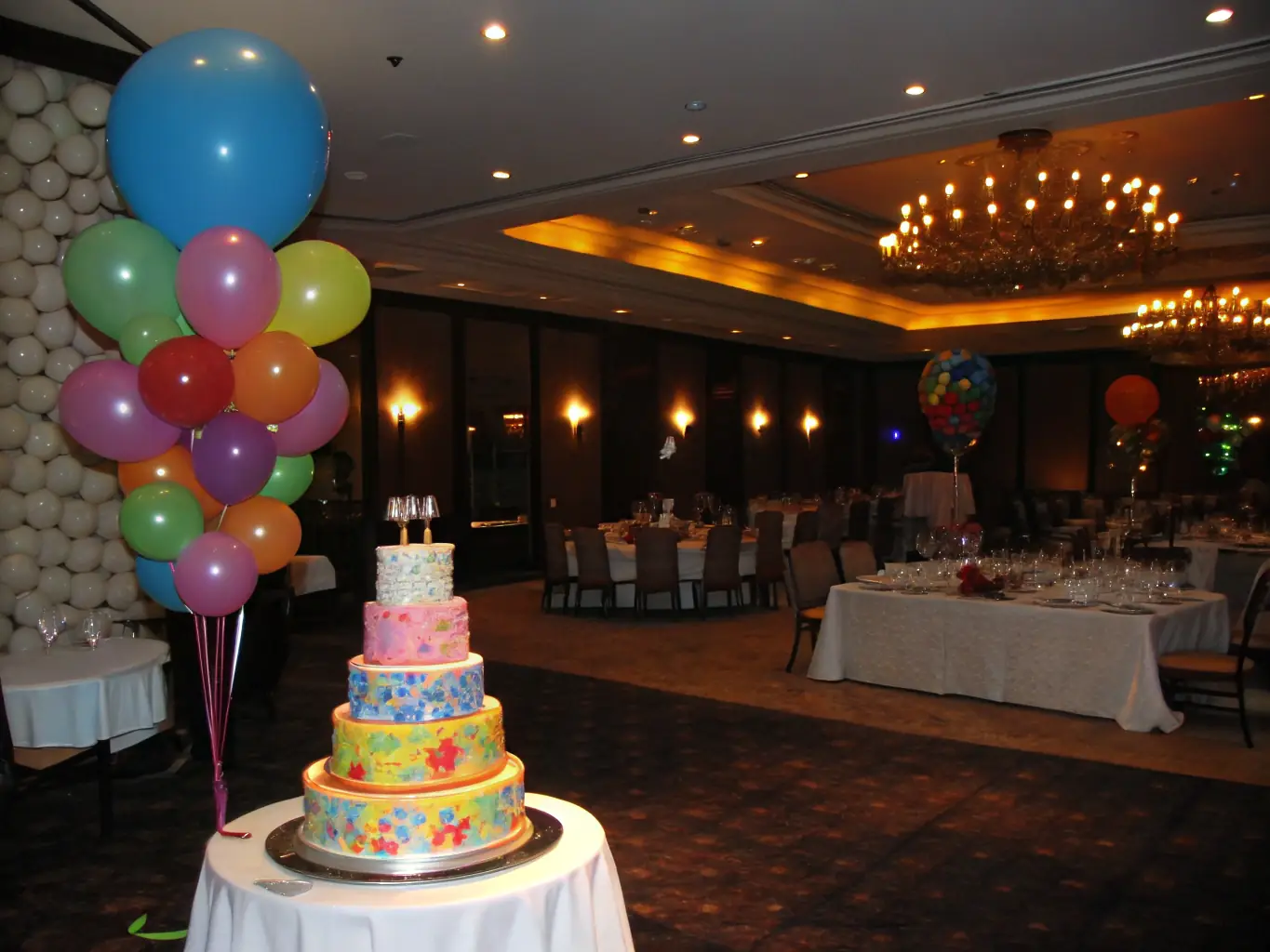 A beautifully decorated party room with balloons, streamers, and a birthday cake on a table, capturing the festive atmosphere and customizable options available for birthday celebrations and special events.